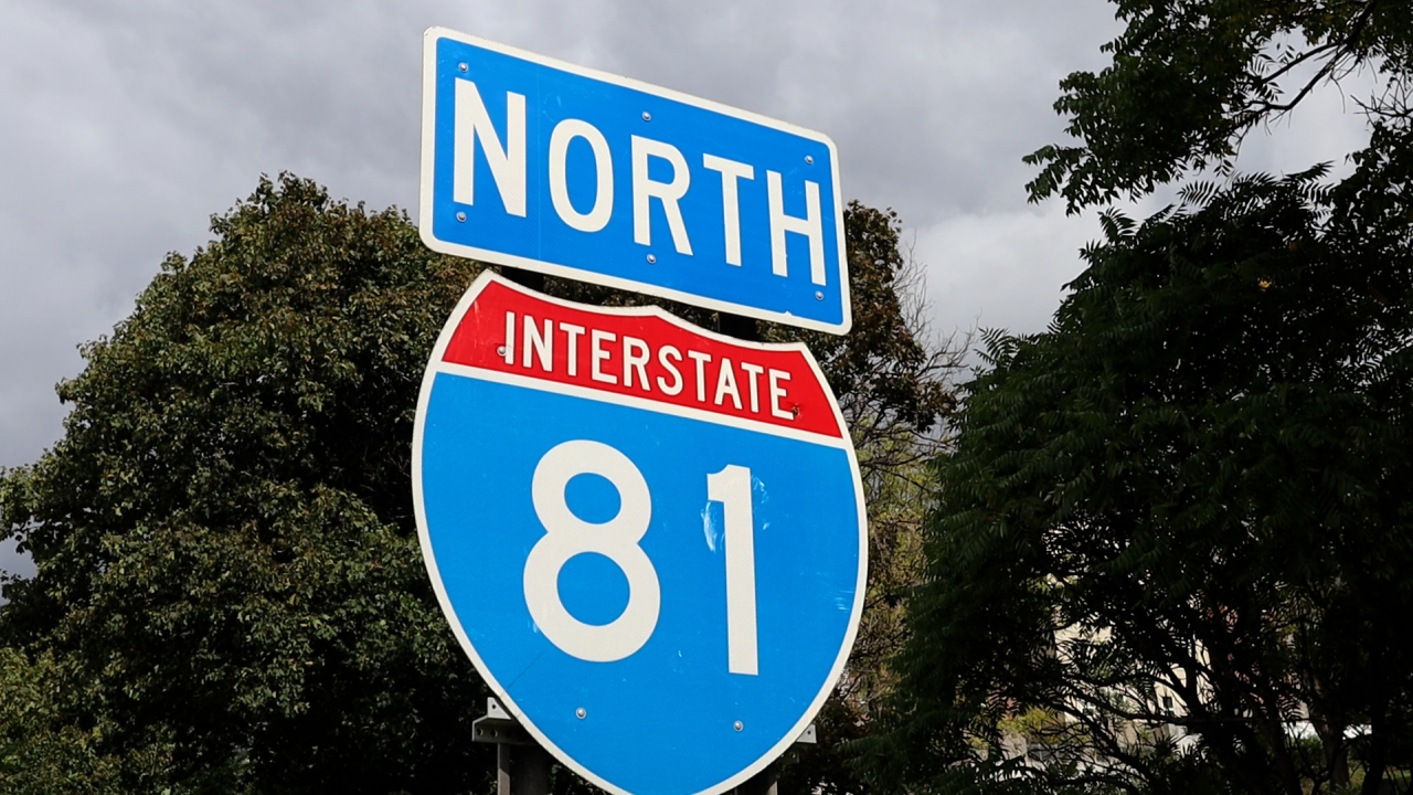 A blue and red sign that reads "North Interstate 81" posted on the side of the Interstate 81 highway.