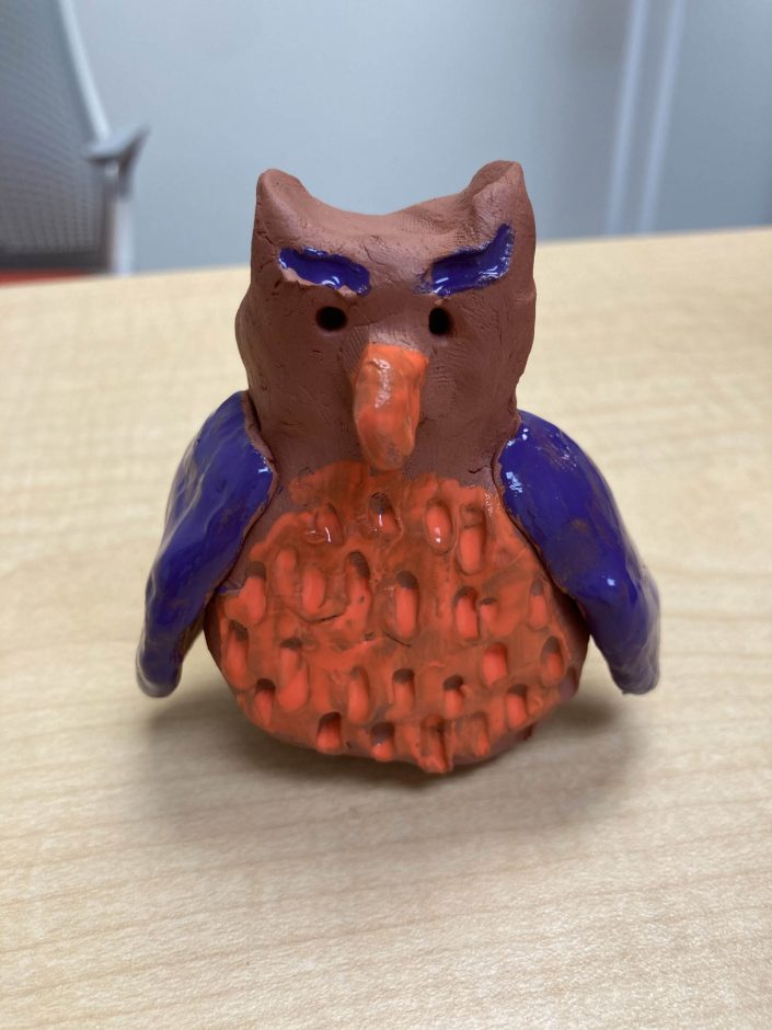 An owl that was crafted by a young artist in 2021 sits on a table..