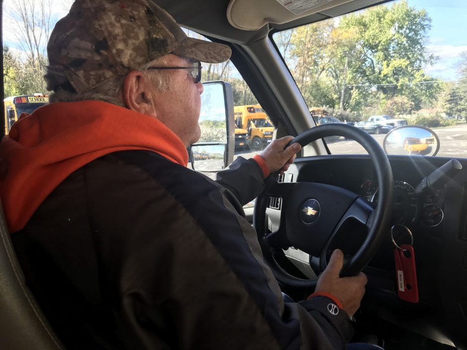 A bus driver drives to get students from school