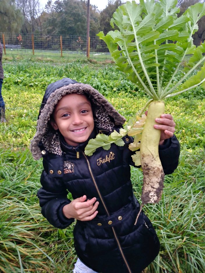 child holding plant