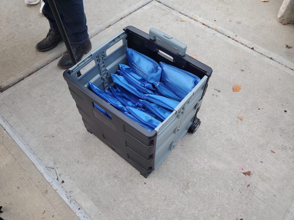 Grey container holding blue substance overdose bags
