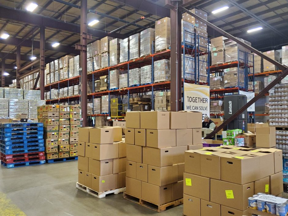Rows of boxes of food and supplies inside the warehouse