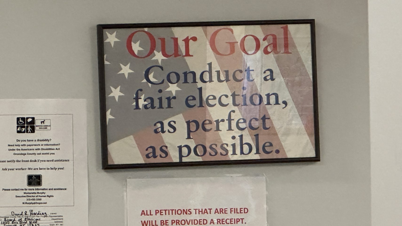 sign saying "our goal: conduct a fair election, as perfect as possible."