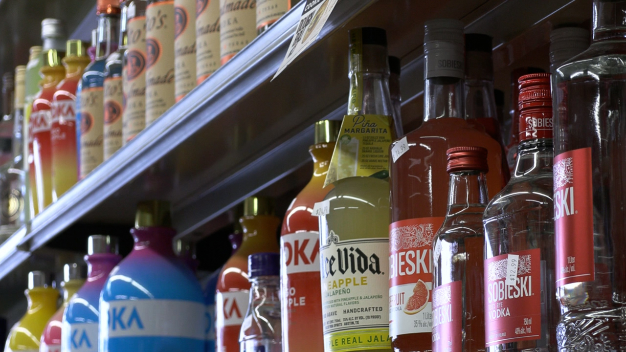 A variety of liquor bottles sit on a shelf at Piraino's Liquor store in Syracuse, NY.