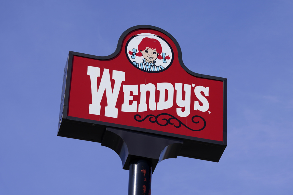 A sign stands over a Wendy's restaurant.