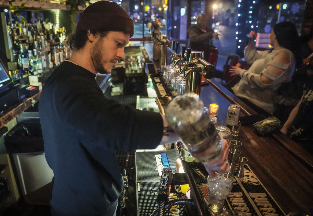 Bartender makes drinks at Fulton Grand Bar in New York