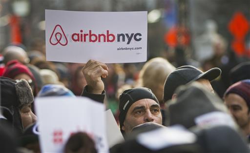 In this Jan. 20, 2015, file photo, supporters of Airbnb hold a rally outside City Hall in New York. The New York state Senate has cleared a bill that would ban companies like Airbnb from advertising apartments from short-term rentals in New York.