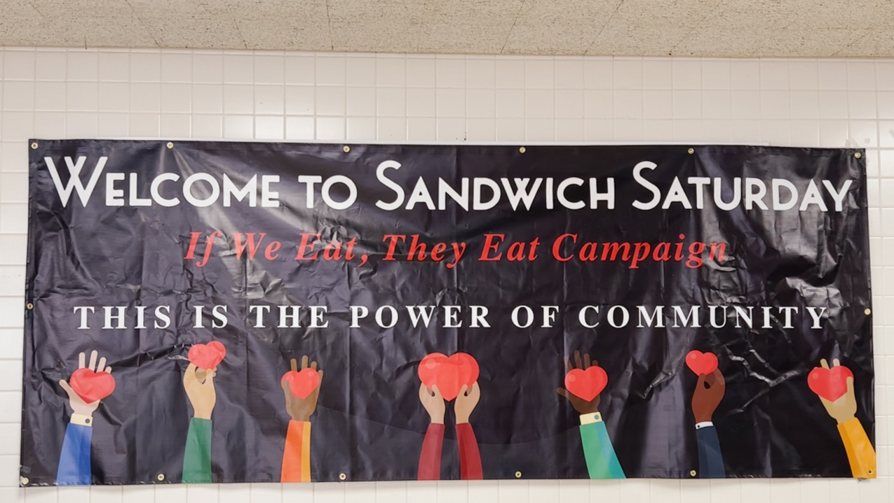 A banner depicting Sandwich Saturday and hands holding hearts.