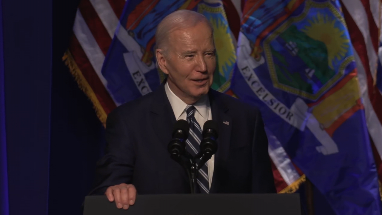 President Biden stands in front of a podium at the MOST.