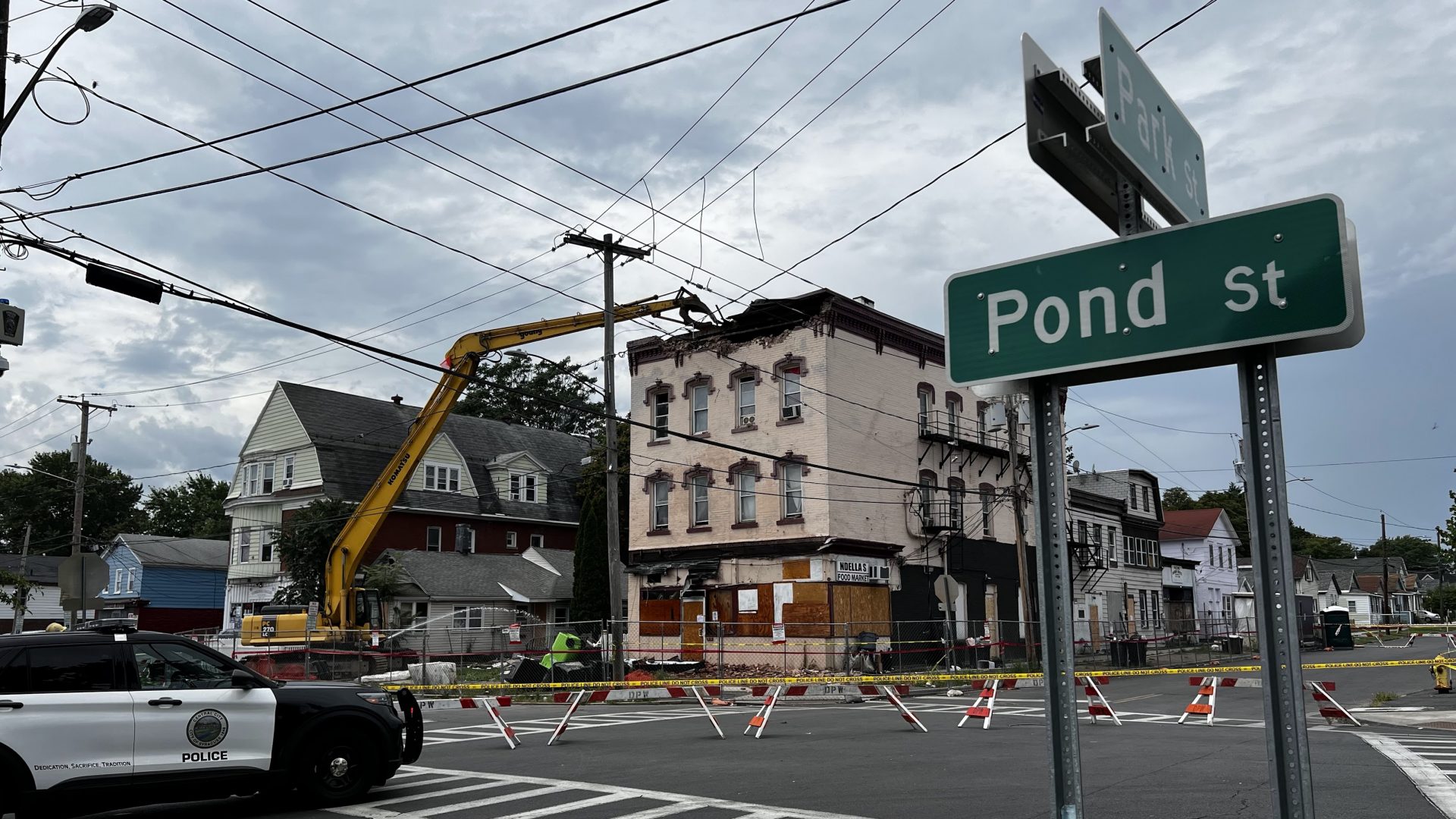 Workers begin tearing down a collapsing building on Pond Street