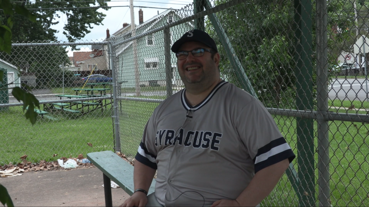 Baseball manager sitting on a bench.