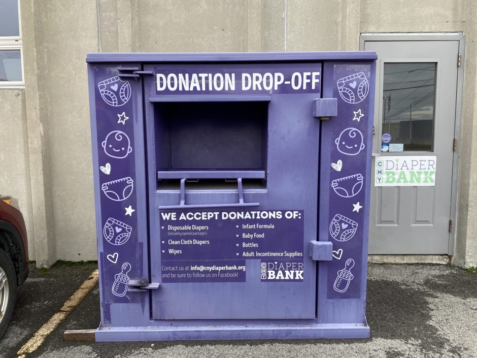 Purple donation bin outside of a building.
