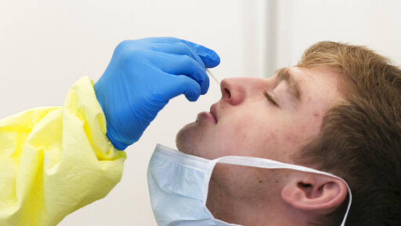 A man recieves a COVID-19 nasal swab test.