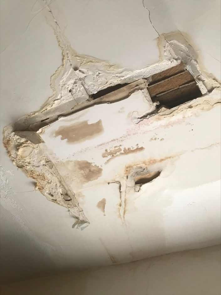 Photo of a water damaged ceiling with lead paint exposed