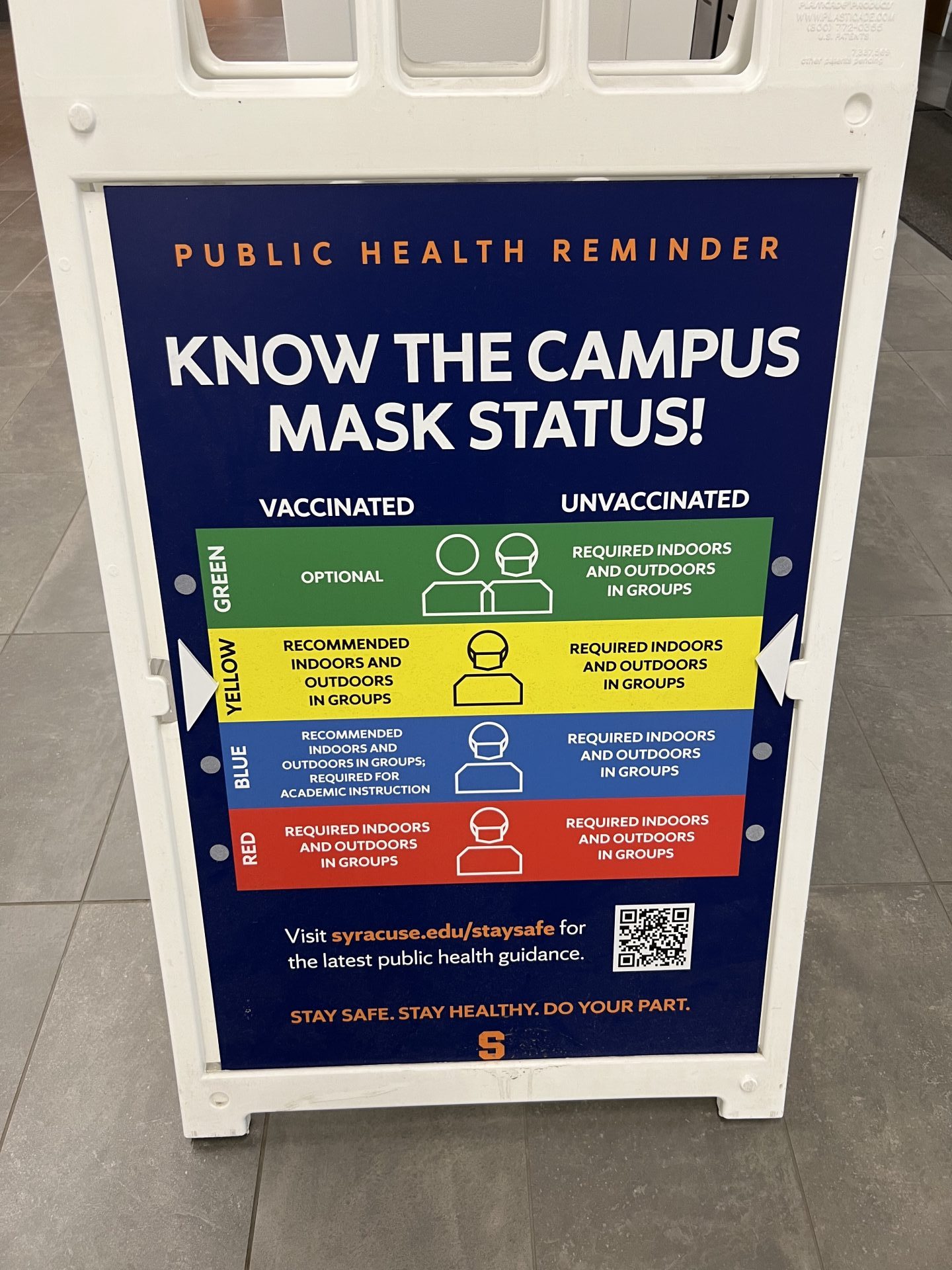 A sign depicts the color-coded mask status at Syracuse.