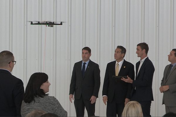 Gov. Cuomo and other people watching a drone.
