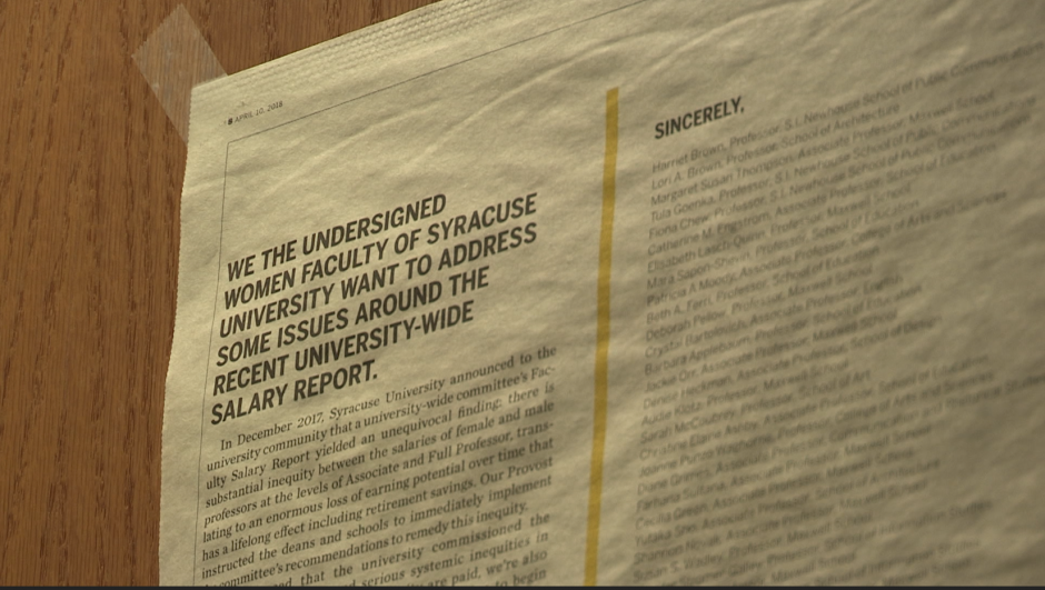 A close-up of the Syracuse University student-run newspaper, The Daily Orange, on the wooden door to Professor Audie Klotz's office.