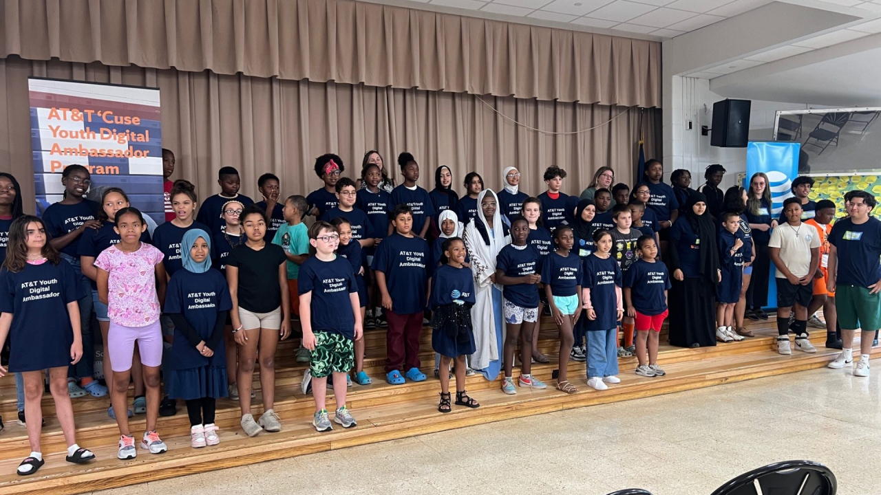 Students on stage together who completed program