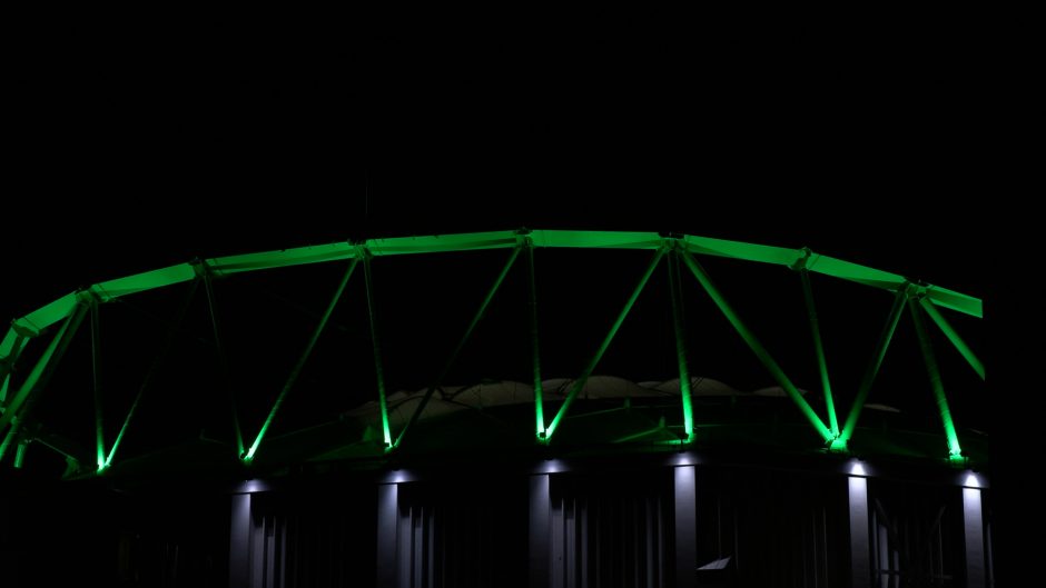 The JMA Dome is lit up green.