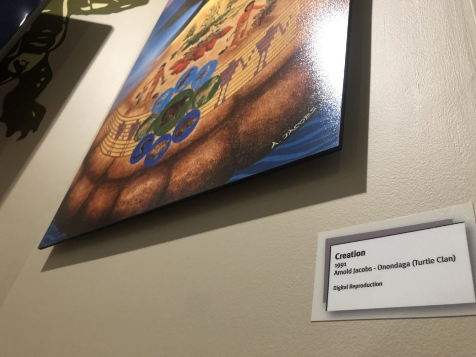 A painting at the center hangs on the wall.