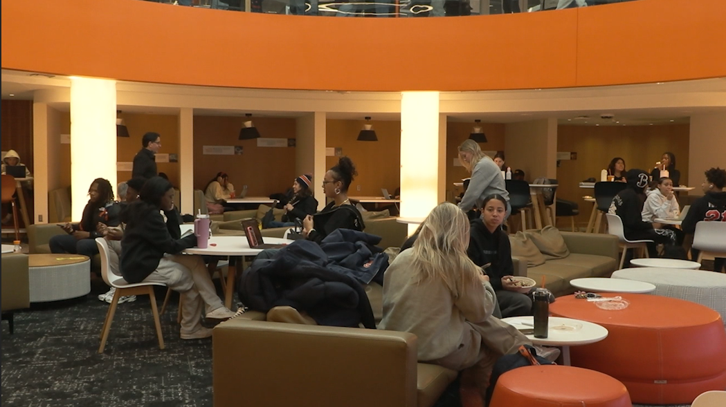 Students at Syracuse University talking within their own groups at Schine student center.