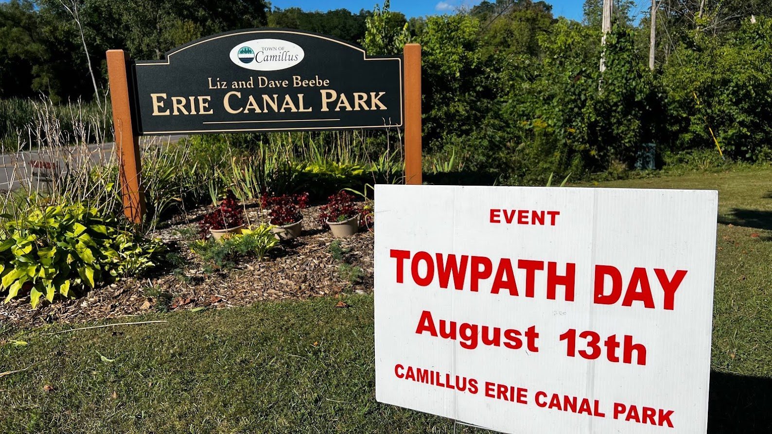 A sign for TowPath Day is displayed in front of the entrance to the Camillus Erie Canal Park