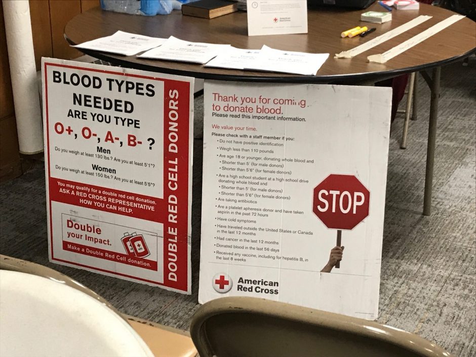 A sign stating the rules for donating blood, and describes the blood types as well