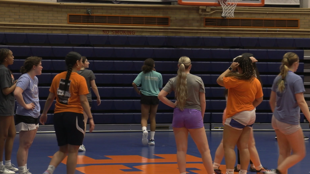 The SU Women's Club Basketball team gathers during practice.