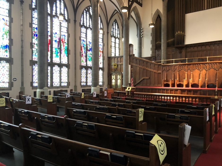 Shows divided up pews due to COVID-19