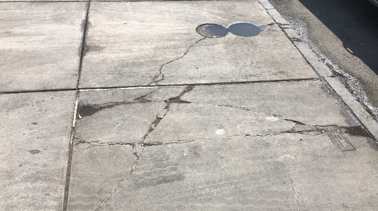 Broken sidewalk in Syracuse.