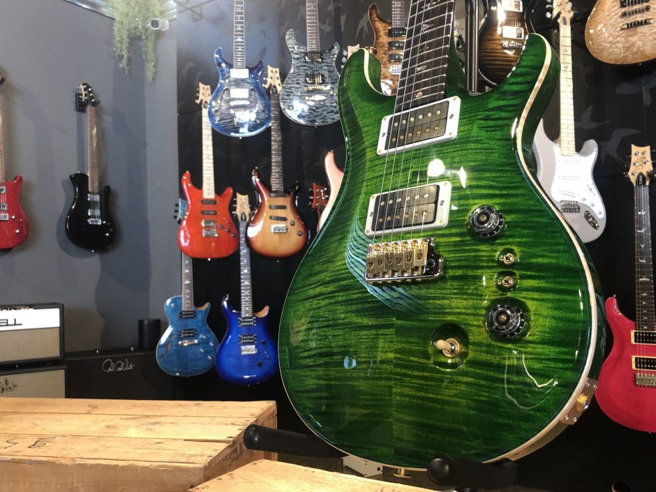 Closeup of guitar in Ish Guitars showroom.