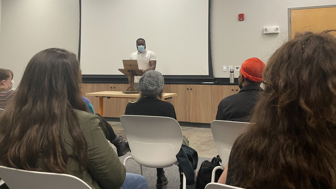 Antwi reads his poetry in front of members of the Syracuse community.