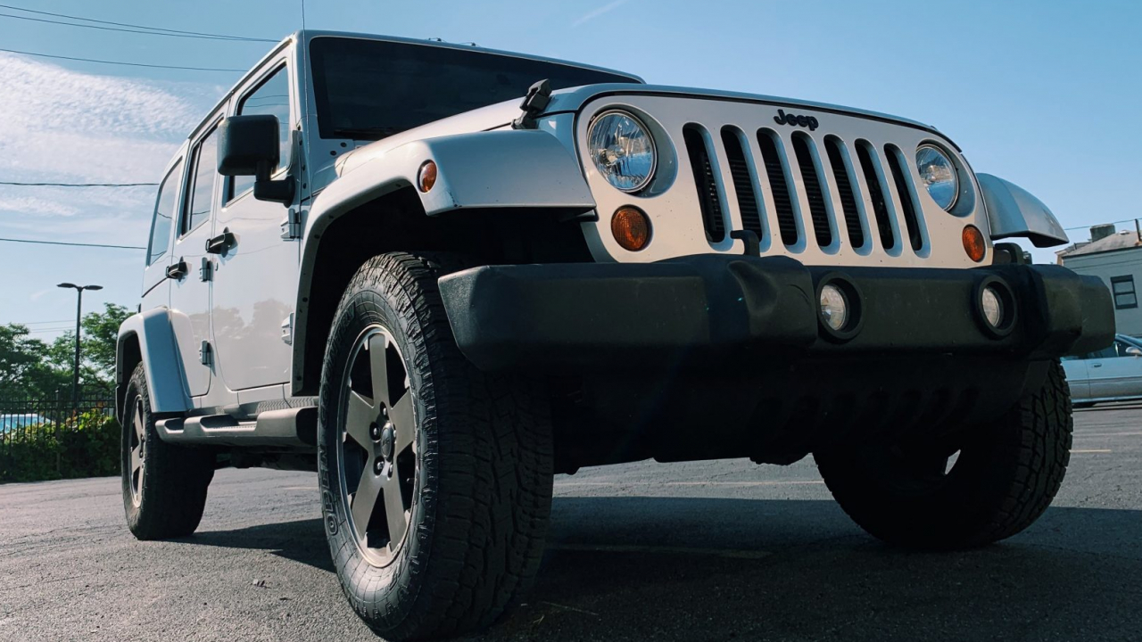 Silver Jeep Wrangler with black rims