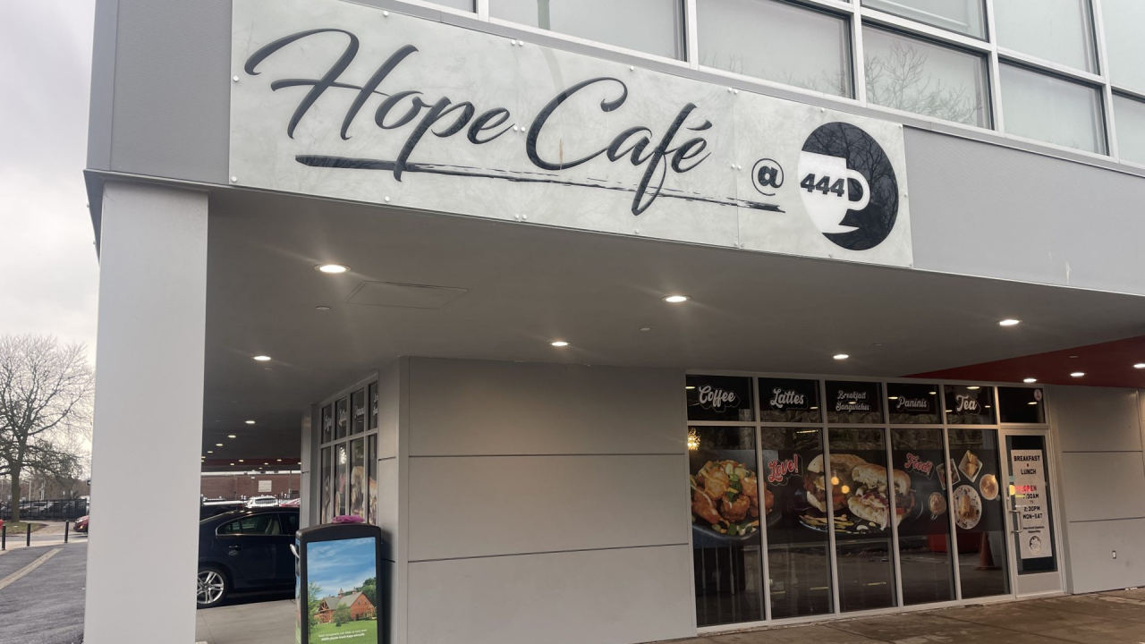A street view of Hope Cafe and Teahouse's signage at the East Genessee Street location.