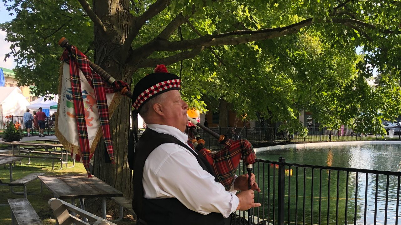 Jack Hines rehearses on his bagpipes by the pond at the NY State Fair.