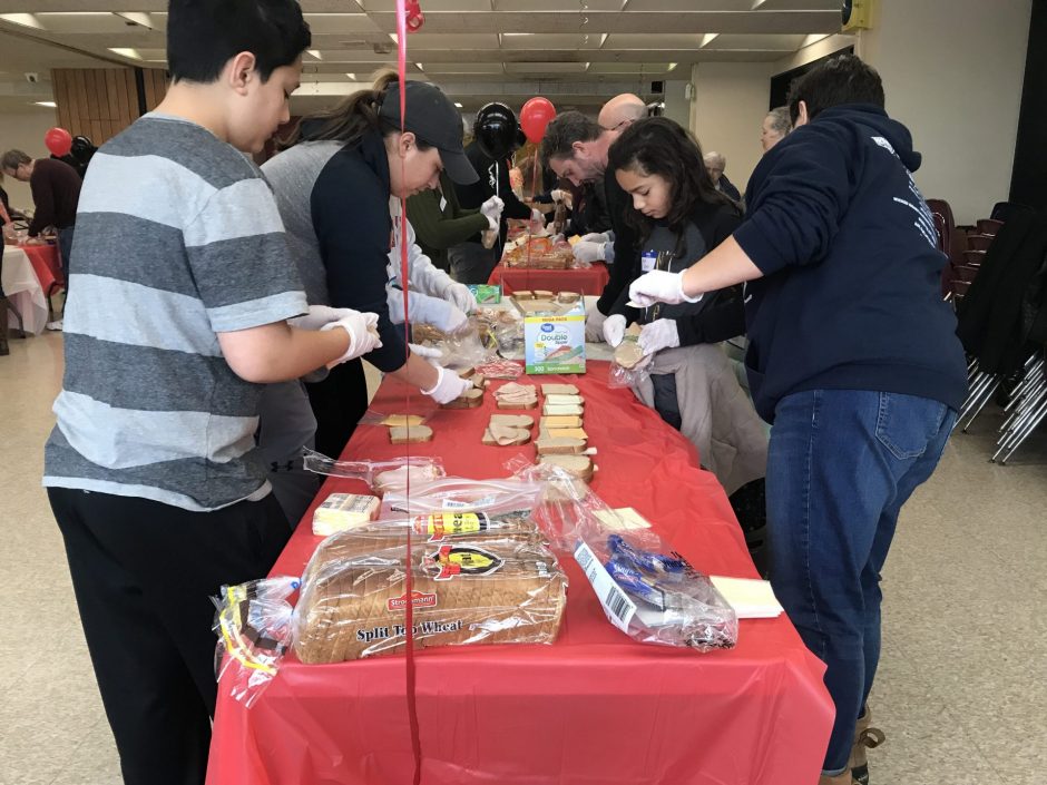 Volunteers make sandwiches to hand out Downtown