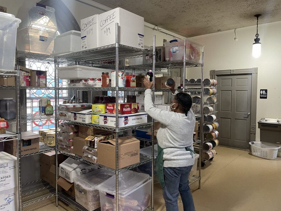 Brenda Mims organizes the canned and stored food in the Samaritan Center.