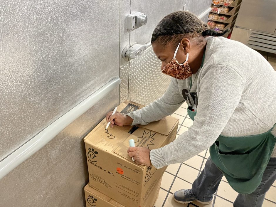 Brenda Mims is labeling the food box to be put in the freezer.