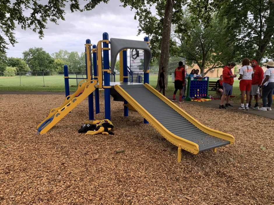 A playground set with a ladder and a slide.