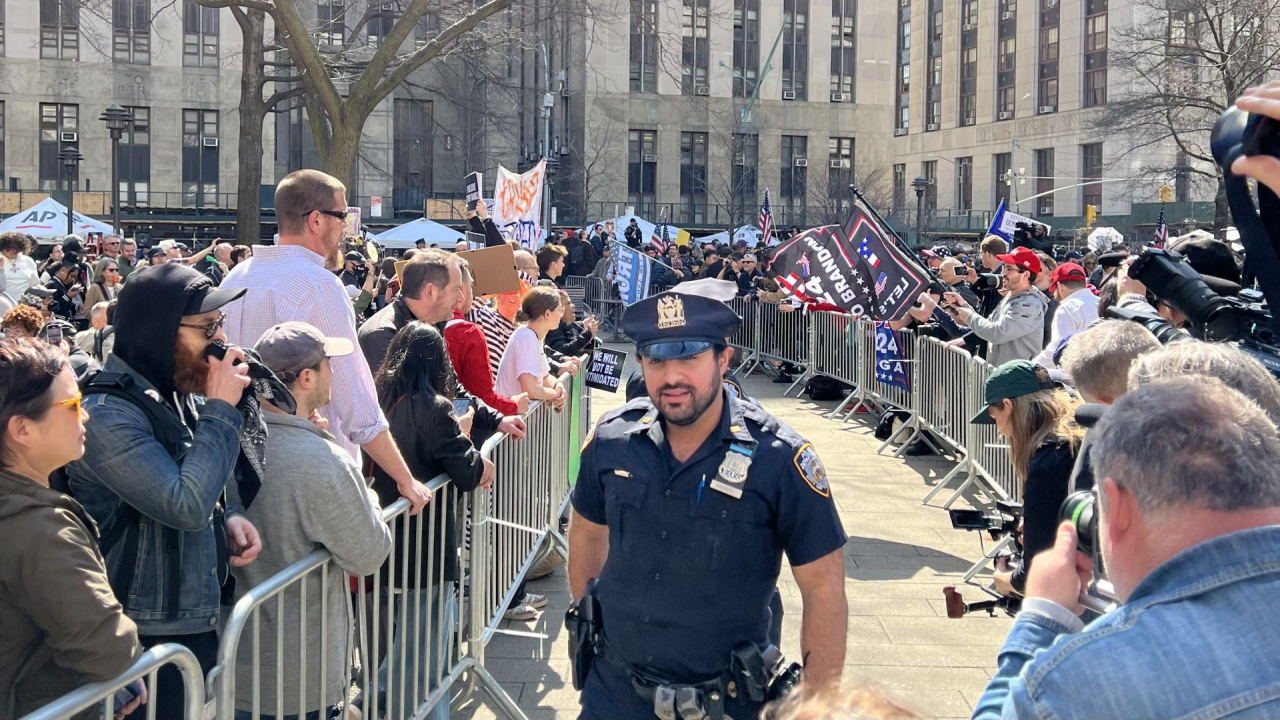 NYPD Officers split the plaza outside the Manhattan Criminal Courthouse by placing barriers between the two groups of protesters.