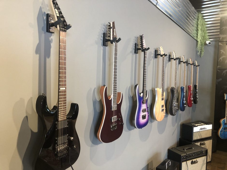 Guitars hanging on the wall in Ish Guitars.