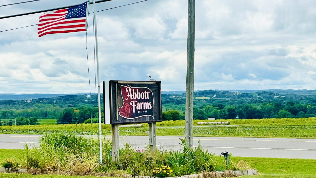The American flag next to the Abbott Farms sign.