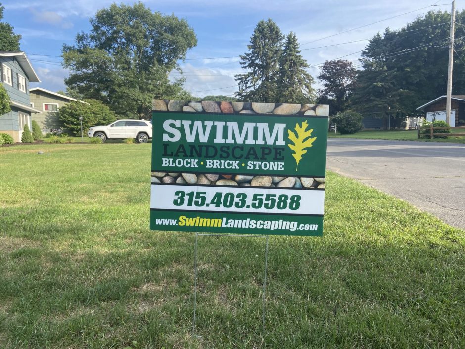 A Swimm Landscaping advertisement displayed on Carolyn Pardee's front lawn.