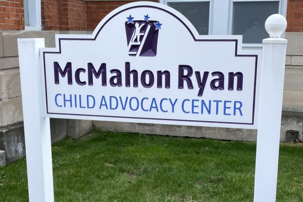 A sign for McMahon Child Advocacy Center outside a building
