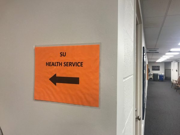 A picture of a sign directing students to Syracuse Health Services.