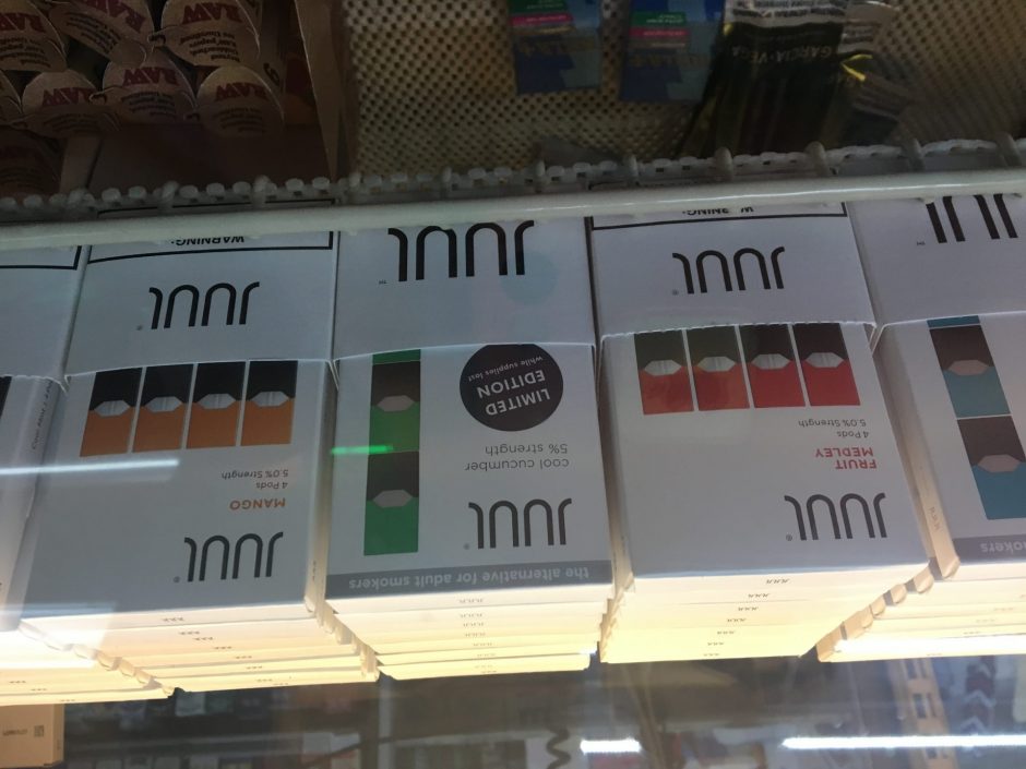 3 packs of Juul brand pods in a display case.