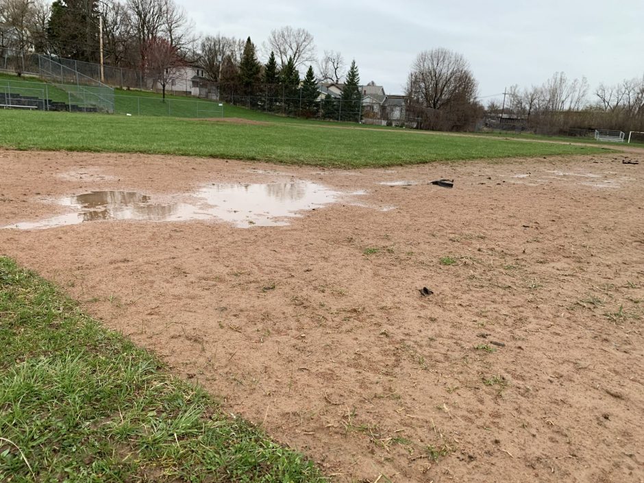 A large puddle at first base on the Fowler High School baseball field.