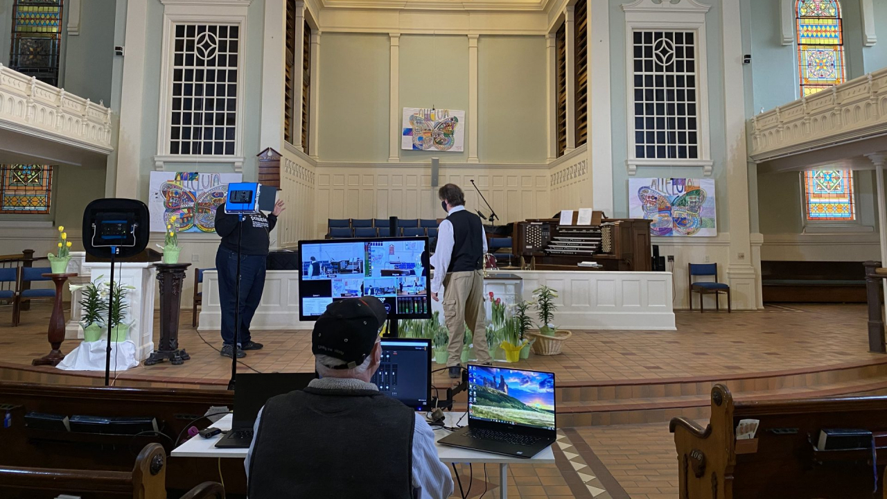 Workers set up live-stream technology at Plymouth Congregational Church for Easter weekend.