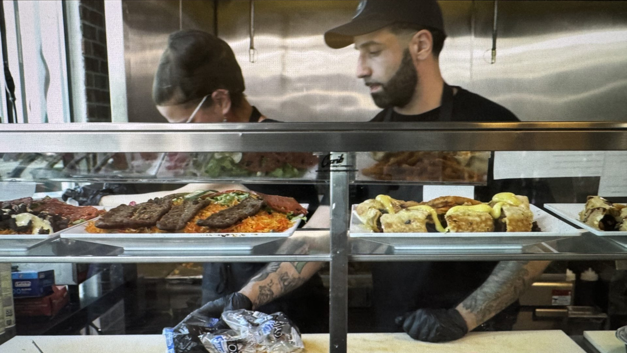 Staff members at Over the Cuse Deli and Grill work through the heat.