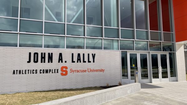The front doors and sign, that reads, "John A. Lally Athletics Complex, Syracuse University," on the front wall that make up the entryway of the John A. Lally Athletics Complex at Syracuse University